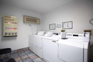 a laundry room with white washers and a air conditioner at Motel 6-Kingman, AZ - Route 66 West in Kingman