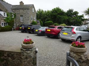 a bunch of cars parked in a parking lot at Yr Hen Felin - The Old Mill B&B in Morfa Nefyn