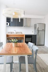 a kitchen with a wooden table with chairs and a refrigerator at Departamento Mar del Plata - Playa Varese - Roque Suarez in Mar del Plata