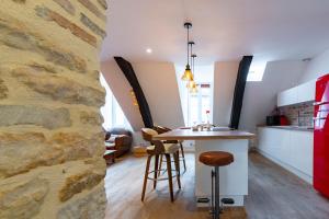 cocina y comedor con pared de piedra en Pasteur Numéro 5 en Dijon