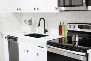 a kitchen with a sink and a stove at Remodeled Modern Ground Level Apt Blocks to Dwntn - B in Tempe