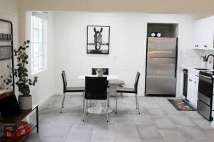 a kitchen with a table and chairs and a refrigerator at Remodeled Modern Ground Level Apt Blocks to Dwntn - B in Tempe