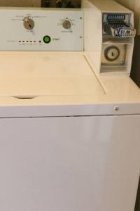 een magnetron bovenop een witte koelkast bij Adorable Ground Level Boho Studio Blocks From Dwntn-C in Tempe