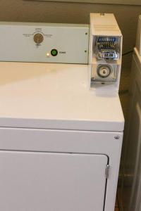 a microwave sitting on top of a white counter at Adorable Ground Level Boho Studio Blocks From Dwntn-C in Tempe +3 photos