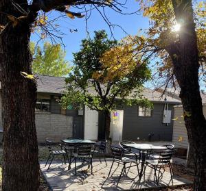 a patio with tables and chairs in front of a house at Adorable Ground Level Boho Studio Blocks From Dwntn-C in Tempe