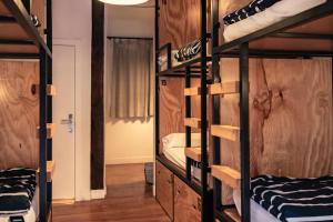 a room with four bunk beds and a hallway at Surfing Etxea - Surf Hostel in San Sebastián