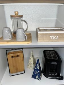 a shelf with a tea pot and a blender at Studio Porte du Croux in Nevers