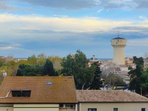 a control tower in a city with a building at Chez Julien & Mathieu in Valras-Plage