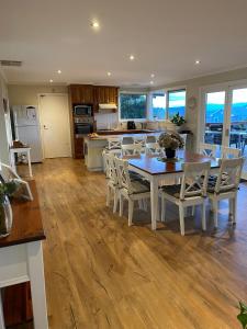 a kitchen and dining room with a table and chairs at The Residence - Yarra Valley in Wandin North
