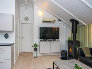 a living room with a tv and a fireplace at 6 person holiday home in Hovborg in Hovborg