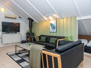 a living room with a couch and a table at 6 person holiday home in Hovborg in Hovborg