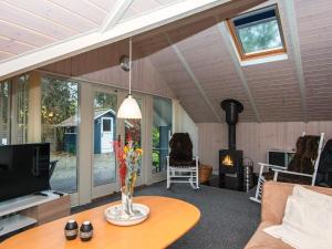 a living room with a table and a fireplace at 7 person holiday home in Ansager-By Traum in Ansager