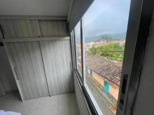 a room with a window with a view of a city at Duplex By Hope in Guatapé