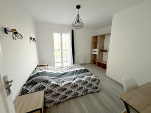 1 dormitorio con 1 cama en el centro de una habitación en 178A - T3 Tout Confort du Gond - 70 m2, en Le Gond-Pontouvre