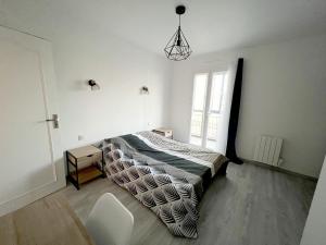 a bedroom with a bed and a chair and a window at 178A - T3 Tout Confort du Gond - 70 m2 in Le Gond-Pontouvre +20 photos
