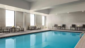 列克星敦的住宿－Staybridge Suites - Lexington S Medical Ctr Area, an IHG Hotel，一座配有桌椅的酒店游泳池