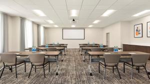 a conference room with tables and chairs and a whiteboard at Staybridge Suites - Lexington S Medical Ctr Area by IHG in Lexington +44 photos