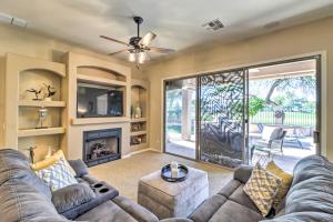 a living room with a couch and a fireplace at Goodyear Home on Golf Course Pool and Putting Green in Goodyear