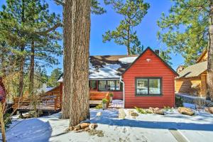 een rood huis in de sneeuw met bomen bij Chic Cali Getaway Short Walk to Big Bear Lake! in Big Bear Lake