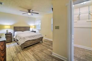 a bedroom with a bed and a ceiling fan at Bright Tallahassee Home with Deck, 3 Mi to FSU! in Tallahassee