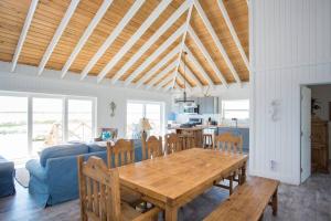 a kitchen and dining room with a wooden table at Sunset Cove in Forbes Hill