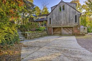 a barn style house with a driveway and a garage at Cozy Dix Hills Apt with Deck about 7 Mi to Beach! in Dix Hills