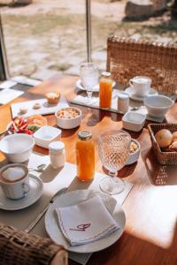 a wooden table with food and drinks on it at Posada Finca Garciarena in Agrelo