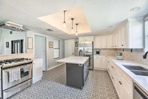 a large kitchen with white cabinets and a counter top at Pet-Friendly Lockhart Home with Private Yard! in Lockhart
