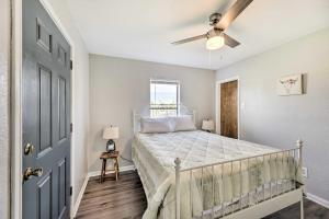 a bedroom with a bed and a ceiling fan at Pet-Friendly Lockhart Home with Private Yard! in Lockhart