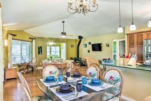 a kitchen and living room with a table and chairs at Breezy Home, 4 Mi to Volcanoes Natl Park! in Volcano