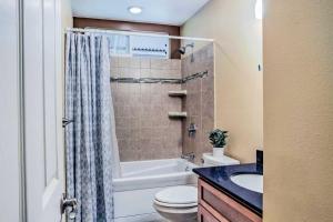 a bathroom with a tub and a toilet and a sink at Breezy Home, 4 Mi to Volcanoes Natl Park! in Volcano +17 photos