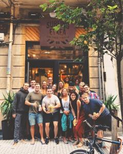 a group of people standing in front of a store at Surfing Etxea - Surf Hostel in San Sebastián
