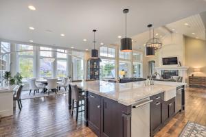 an open kitchen and living room with a large island at Luxe Sandy Home with Hot Tub 9 Mi to Skiing! in Sandy