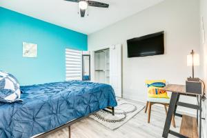 a bedroom with a bed and a desk and a tv at Sea Crest in Galveston