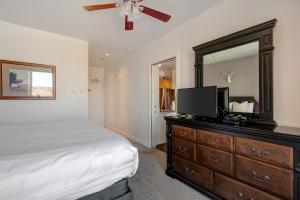 a bedroom with a bed and a dresser with a mirror at The Lodge at Stillwater #2012 in Heber City