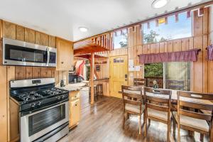 a kitchen with wooden walls and a stove top oven at Black Diamond Vista in Big Bear Lake