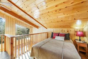 a bedroom with a bed in a wooden cabin at Black Diamond Vista in Big Bear Lake