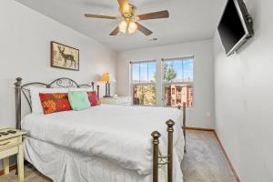 a bedroom with a bed and a ceiling fan at Jordanelle Jubilee in Heber City