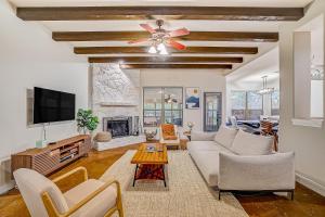a living room with a couch and a ceiling fan at Stargazer Ranch in Dripping Springs