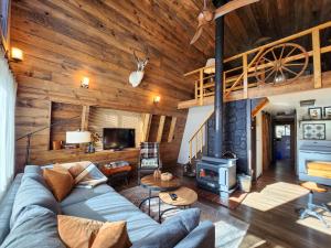 a living room with a blue couch and a fireplace at Cozy Cabin Near Bryce and Zion sleeps 4 adults in Duck Creek Village