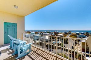 a balcony with chairs and a view of the ocean at The Indies #609 in Fort Morgan