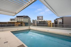 a swimming pool on the roof of a building at Lovely 2- Bedroom Rental Unit with Free Parking in Brisbane