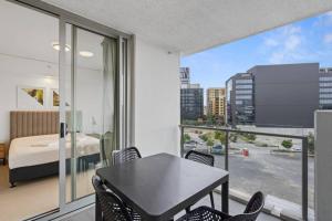 a room with a table and chairs and a bedroom at Lovely 2- Bedroom Rental Unit with Free Parking in Brisbane