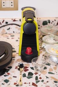 a table with a yellow juicer with a strawberry on it at The Red-Hot Retro Studio Cairo's Downtown in Cairo