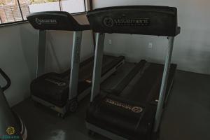 a gym with two pieces of equipment in a room at Pousada Algodão da Praia in Araruama