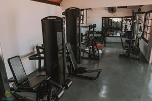 a gym with several treadmills and machines in a room at Pousada Algodão da Praia in Araruama