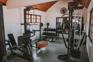 a gym with several tread machines in a room at Pousada Algodão da Praia in Araruama