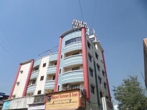 a building with a sign on the top of it at Hotel Shelter Palace in Navi Mumbai