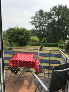 a red and white table and chairs on a porch at Pension Martens - Lotte in Wieck