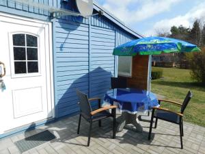 a table and chairs with an umbrella on a patio at Haus Krüger in Wieck